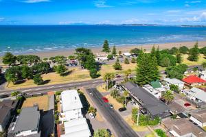 an aerial view of a town with the beach at Orewa Beachcomber in Orewa