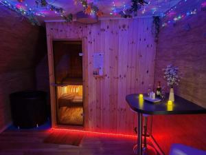 a room with a table and a pink wall at Little Paradise Spa Appartement in Gummersbach