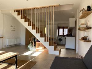 a living room with a staircase in a house at Lupara Bella in Lupara
