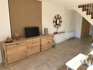 a living room with a television on a wooden dresser at Lupara Bella in Lupara
