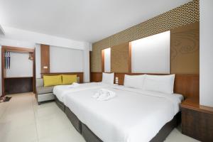 Postel nebo postele na pokoji v ubytování Cozytel Chiangmai