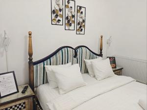a bedroom with a bed with white sheets and pillows at Stay In Tmisoara in Timişoara