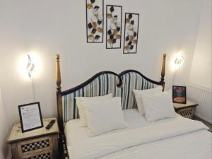 a bedroom with a bed with white sheets and pillows at Stay In Tmisoara in Timişoara