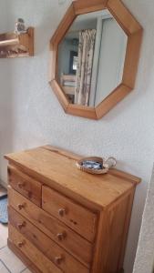 a wooden dresser with a mirror on top of it at Signal du Prorel Briançon Serre Chevalier "QOCLICO" in Briançon