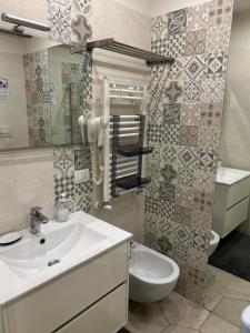 a bathroom with a sink and a toilet and a mirror at SanBiagio, 25 Guesthouse in Naples +29 photos