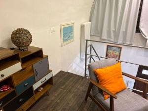 a living room with a chair and a bunk bed at SanBiagio, 25 Guesthouse in Naples