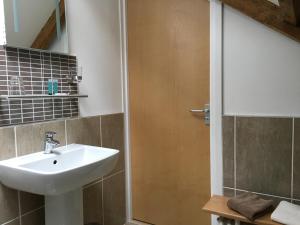 a bathroom with a sink and a shower at Kings Head in Capel Hendre