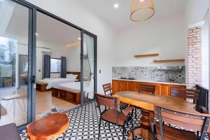 a room with a table and chairs and a bedroom at Như House Apartment Phú Quốc in Phu Quoc
