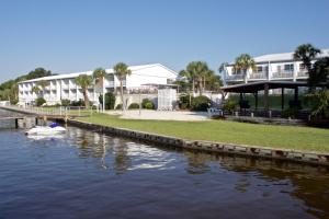 a boat in the water in front of a building at Marina Bay Resort in Fort Walton Beach