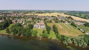 an aerial view of a house on an island in the water at Seevilla West am Großen Plöner See in Ascheberg