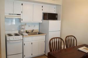 a kitchen with a white refrigerator and a sink at Marina Bay Resort in Fort Walton Beach