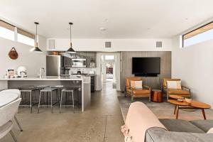 a kitchen and living room with a couch and a table at Steel & Solace By The Cohost Company in Pioneertown