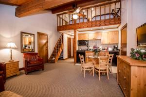 a kitchen and dining room with a table and chairs at Kandahar Lodge at Whitefish Mountain Resort in Whitefish
