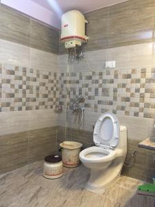 a bathroom with a white toilet in a room at Shimla View Home in Shimla +100 photos