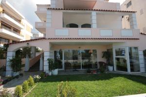 a house with a lawn in front of it at Parthenis Riviera Hotel in Athens