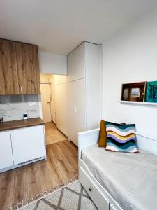 a small bedroom with a bed and a kitchen at Apartmán v centre in Nové Mesto nad Váhom +2 photos