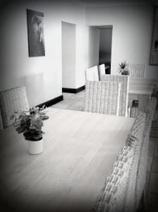 a black and white photo of a table and chairs at 47th on Howard in Knysna