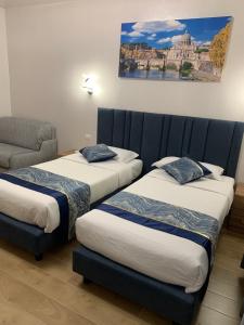 a room with two beds and a couch at Vatican Bliss in Rome