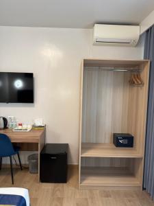 a room with a bed and a desk and a book shelf at Vatican Bliss in Rome