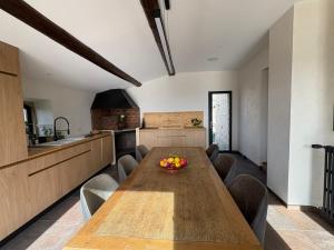 a kitchen with a wooden table with a bowl of fruit on it at La Magnanerie Maison Provençale in Gordes