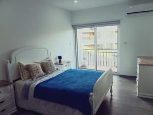 a bedroom with a bed and a large window at Casa da Angelina in Ponte da Barca