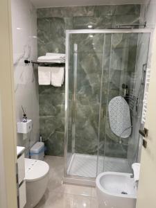 a bathroom with a shower with a toilet and a sink at Vatican Bliss in Rome