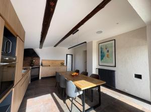 a kitchen and dining room with a table and chairs at La Magnanerie Maison Provençale in Gordes