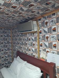 a bedroom with a wall with pictures of animals at Ibrahim Garden Hostel in Arusha