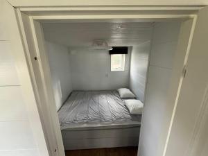 a small bedroom with a bed in a small room at Suncity Solsidan in Borgholm