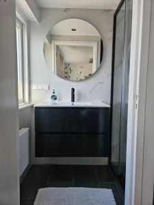 a bathroom with a sink and a mirror at Have a nice stay! - North Sea Home in Noordwijk aan Zee +19 photos