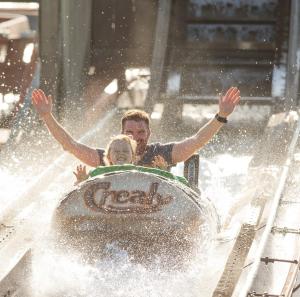a man and a woman riding an elephant on a roller coaster at Countryside Retreat with Hot Tub in Haselbury Plucknett