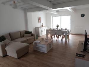 a living room with a couch and a table at Au bord de l'Helpe in Liessies