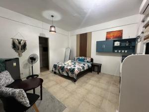 a bedroom with a bed and a chair in it at Paradise Beach Apartment in Boracay