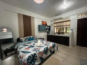 a bedroom with a bed and a kitchen in it at Paradise Beach Apartment in Boracay