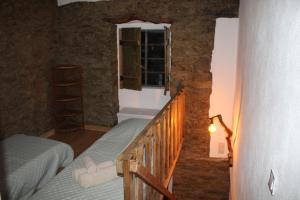 a small room with a bed and a window at Piscina Interior aquecida - Monte Cimeiro e Casitas da Eira - Casa da Ti Carminha in Mação
