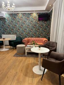 a living room with a couch and chairs and a table at Hotel Delle Rose in Mestre +41 photos