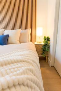 a bedroom with a white bed with a wooden headboard at Luxury Scandinavian Suite Cozy and Bright in North Vancouver +76 photos