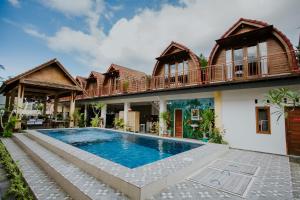 a house with a swimming pool in front of it at Garuda Dive & Accomodation Nusa Penida in Nusa Penida +48 photos