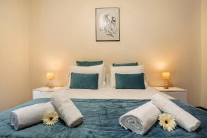 a bedroom with a large bed with flowers on it at Madeira Funchal Gardens in Funchal +69 photos
