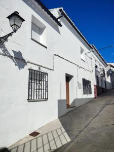 een wit gebouw met een raam en een straat bij Casa del Tío Paco in Montecorto