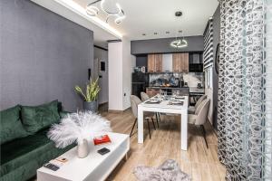 a living room with a green couch and a table at K-Alex Domus in Alexandroupoli in Alexandroupoli