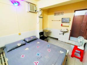 a room with a bed in a hospital room at Jade Crown in Yangon