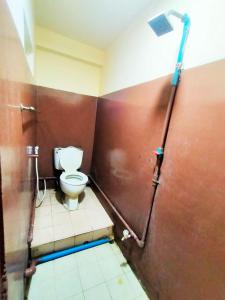 a bathroom with a toilet in a bathroom stall at Jade Crown in Yangon