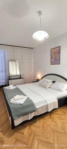 a bedroom with a large bed and a light at Apartman Ana Mina in Crikvenica +12 photos