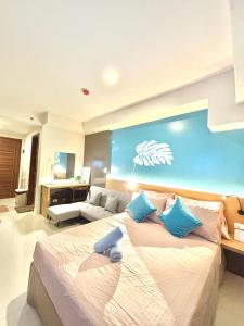 a bedroom with a large bed and a couch at mrbed in Cebu City