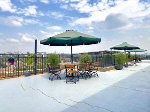 a patio with a table and chairs and umbrellas at The Ikhaba Loft in Nairobi