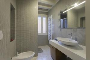 a bathroom with a sink and a toilet and a mirror at Mia Casa in Venice
