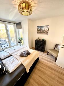a bedroom with a large bed and a large window at Ferienwohnung Markkleeberg Zentrum in Markkleeberg