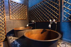 a bathroom with two tubs and a blue wall at 貸切御宿Villa EL 5 Nikko Kinugawa Area in Nikko +79 photos