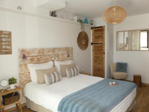 a bedroom with a large bed with a blue blanket at Studios Nuitée en Provence in Aix-en-Provence +40 photos